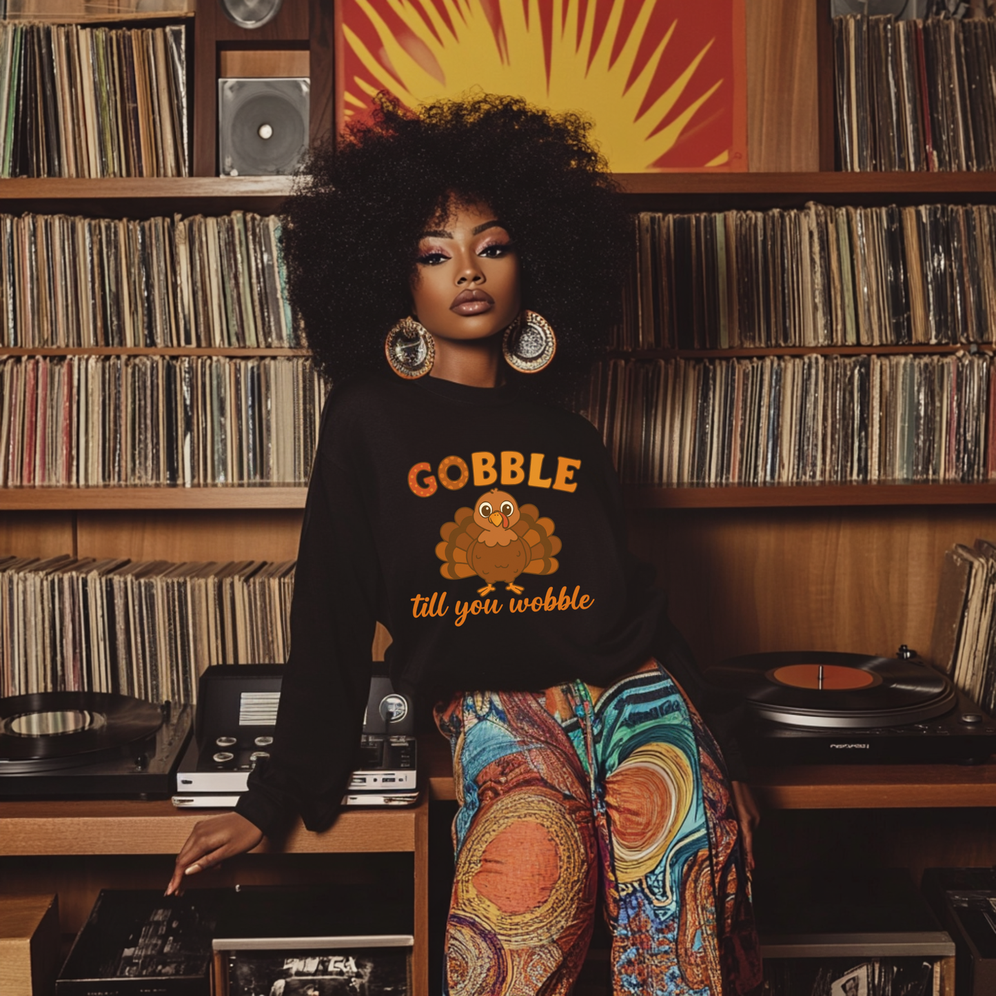 Woman wearing a black sweatshirt with 'Gobble till you wobble' text in a record store.